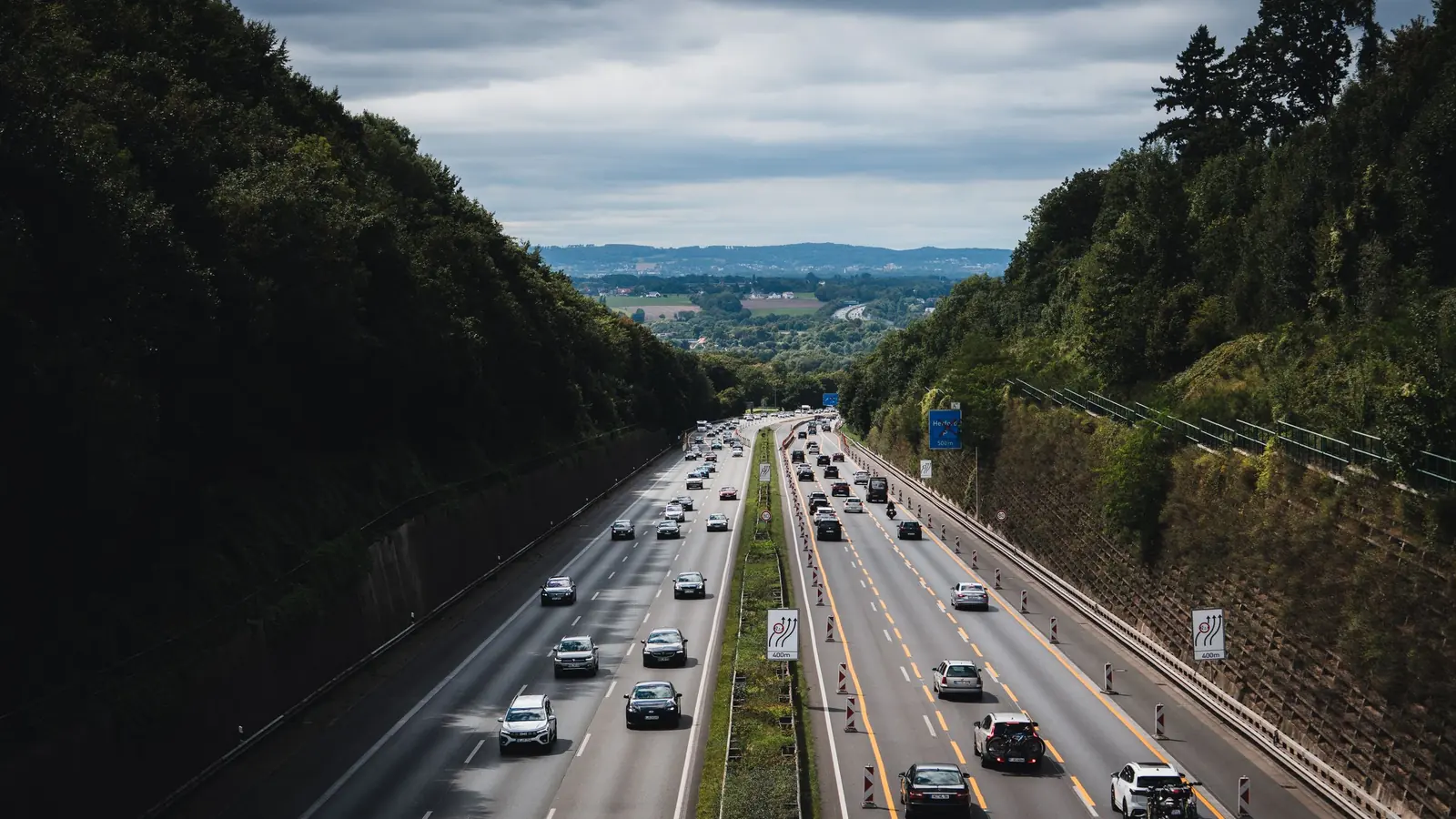 Motorway through a wooded valley in Germany – driving to Berlin (BER) Airport