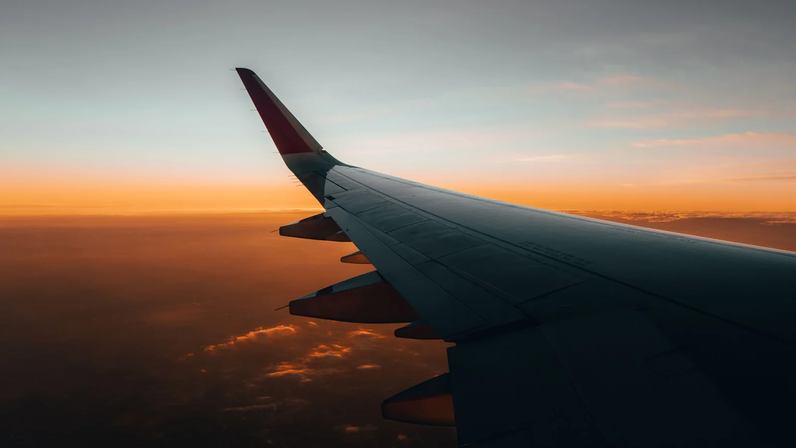 Wing in the first morning light above the horizon – parking for an early flight at Cologne/Bonn Airport