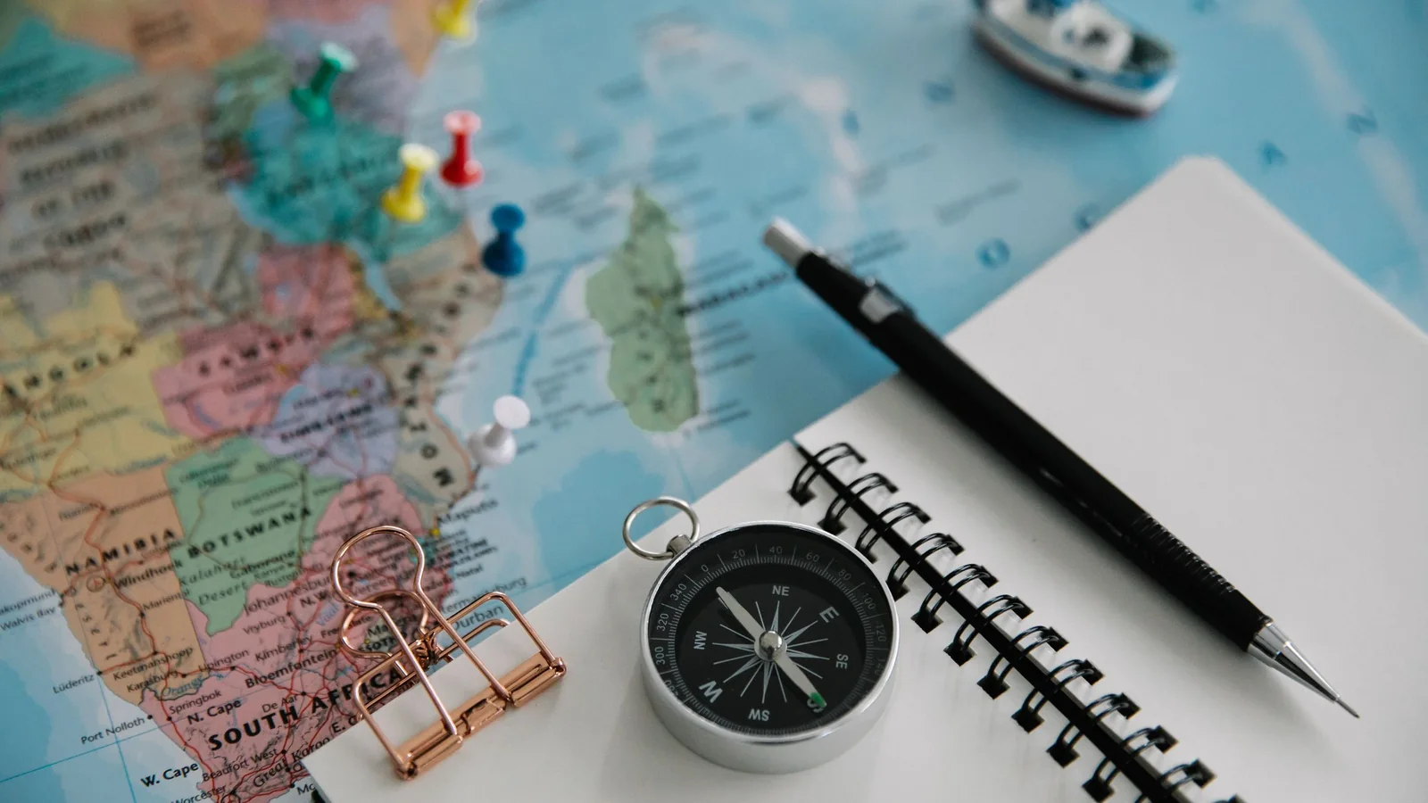 Map with pins, compass and notebook – reserving a car park at Cologne/Bonn Airport